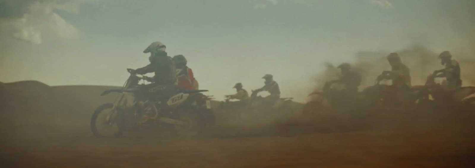 a group of people riding on the back of motorcycles
