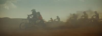 a group of people riding on the back of motorcycles