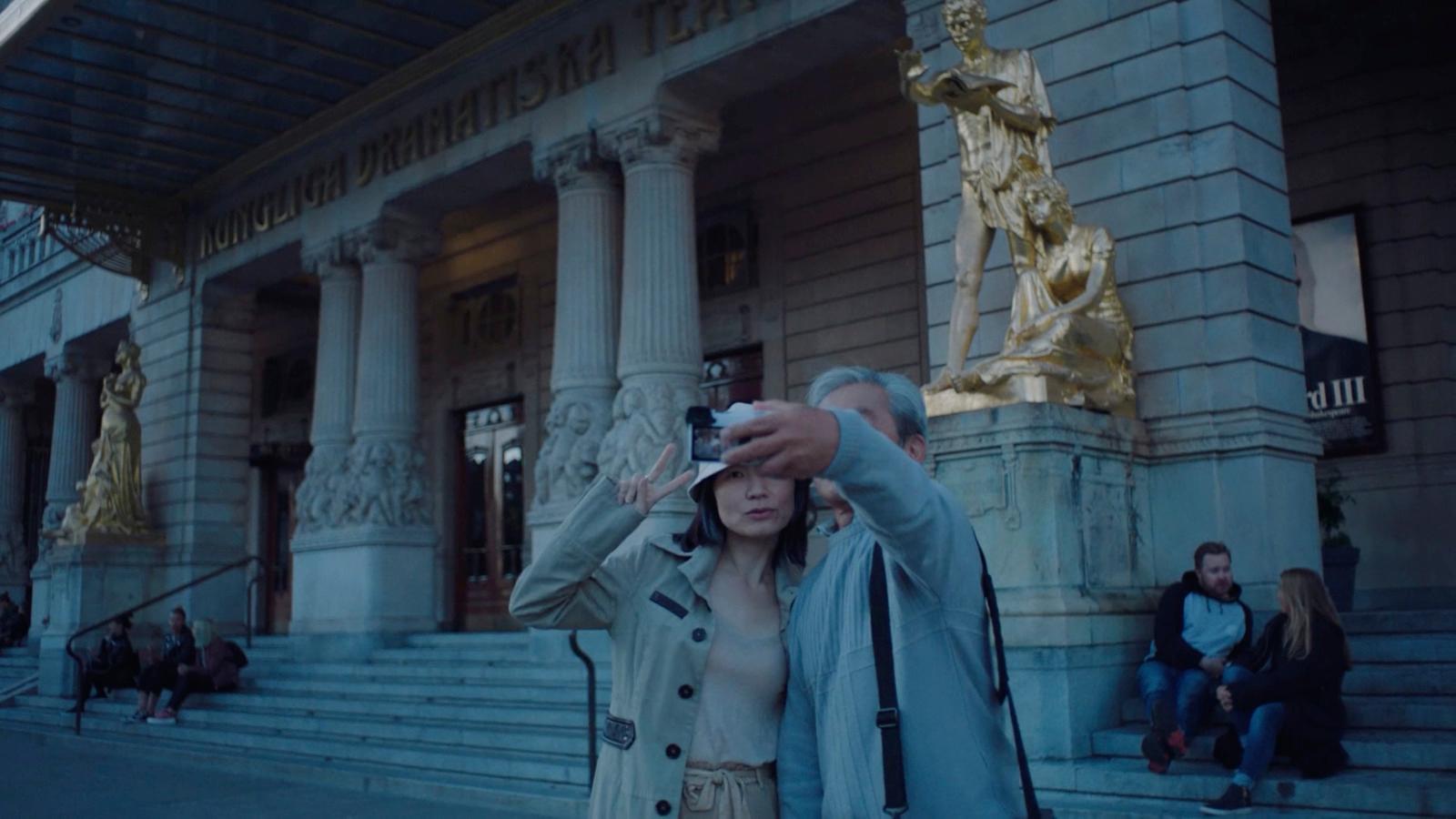 a woman taking a picture with her cell phone