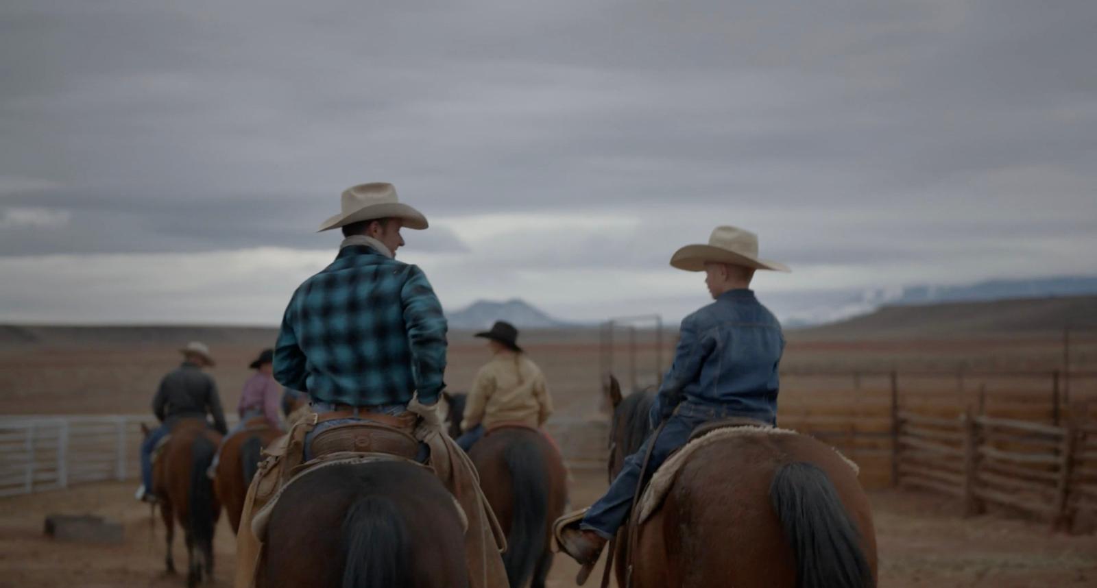 a group of men riding on the backs of brown horses