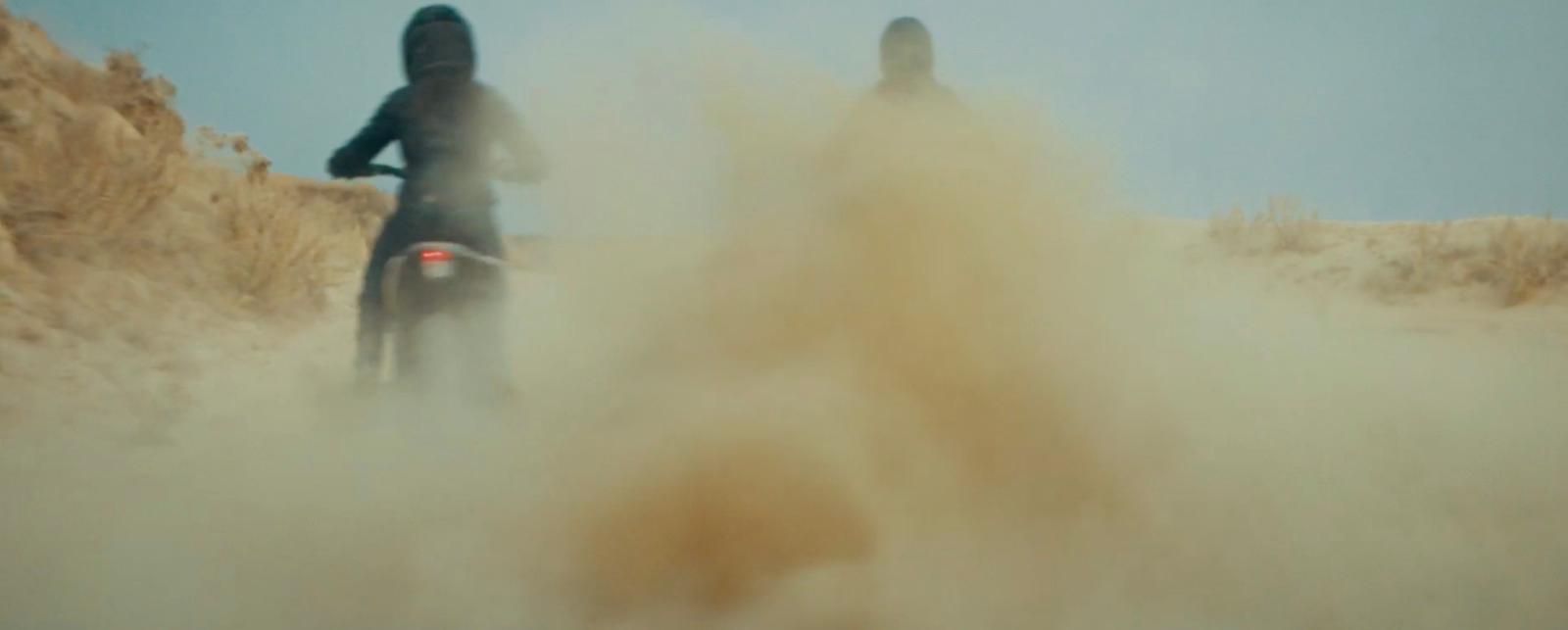 a couple of people riding on the back of a motorcycle