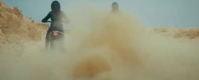 a couple of people riding on the back of a motorcycle