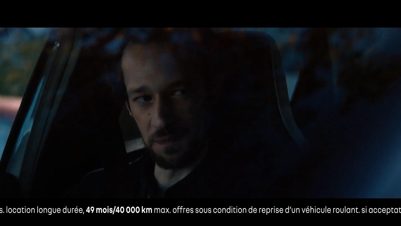a man driving a car in the dark