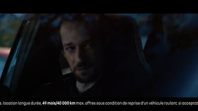 a man driving a car in the dark