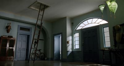 a room with a ladder and a bicycle in it