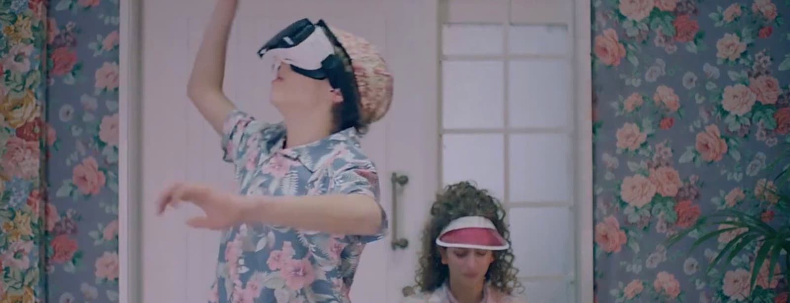 a woman wearing a blindfold standing next to another woman
