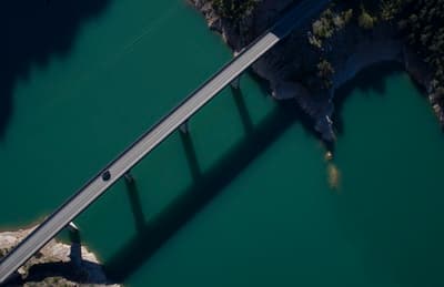 an aerial view of a bridge over a body of water