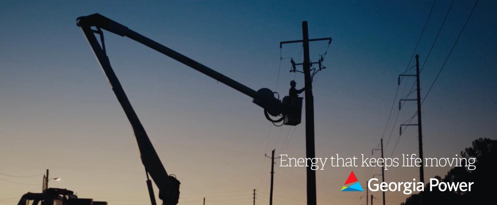 an electrician is working on a power pole