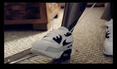 a pair of white and black sneakers on the ground