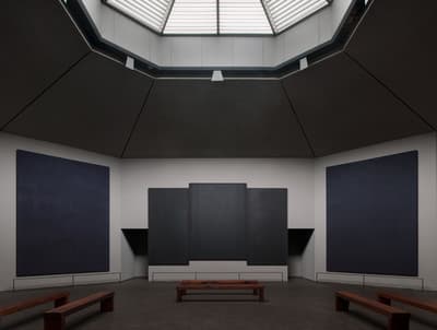 an empty room with benches and a skylight