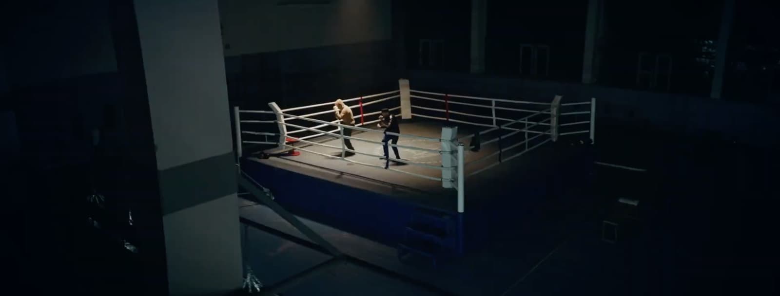 a man standing on top of a boxing ring