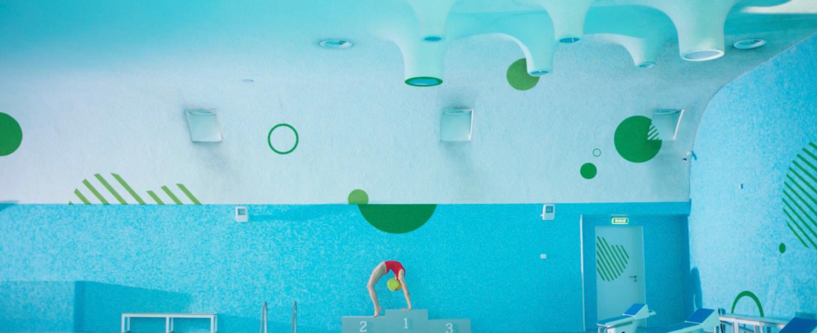 a room with a pool and a clock on the wall