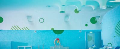 a room with a pool and a clock on the wall