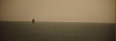 a person standing in the middle of a large body of water