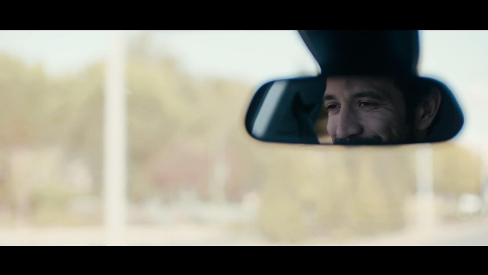 a man is looking out of a car window