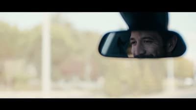 a man is looking out of a car window