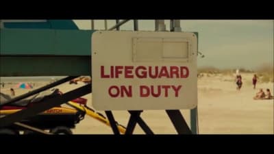 a lifeguard on duty sign on a beach