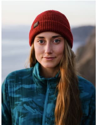 a woman with long hair wearing a red hat