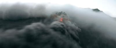 a train on a train track surrounded by smoke