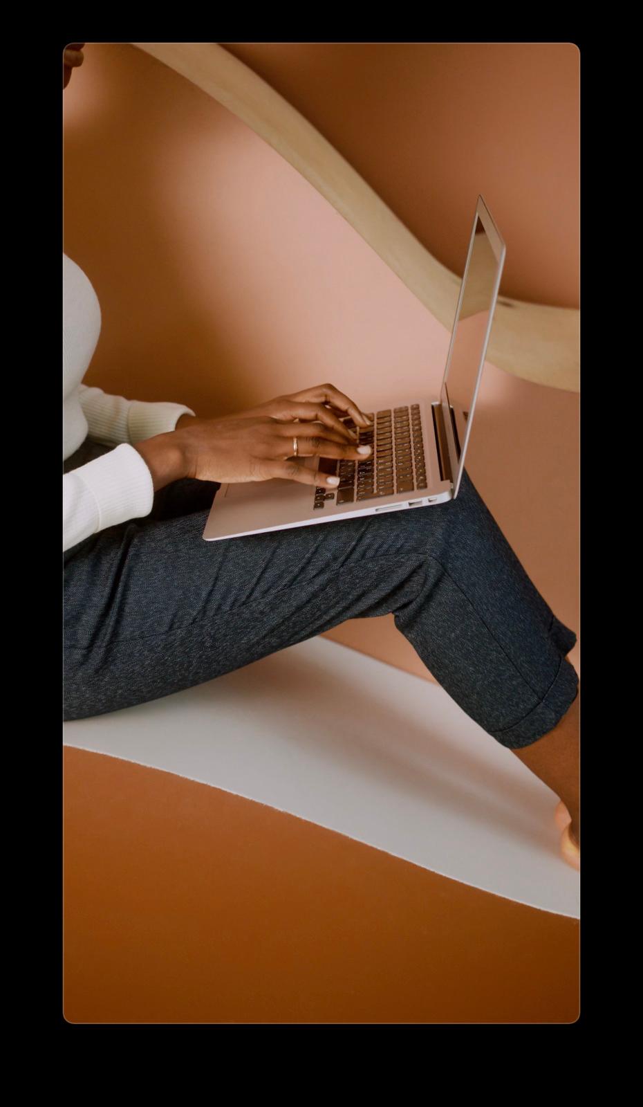a person sitting on a chair with a laptop