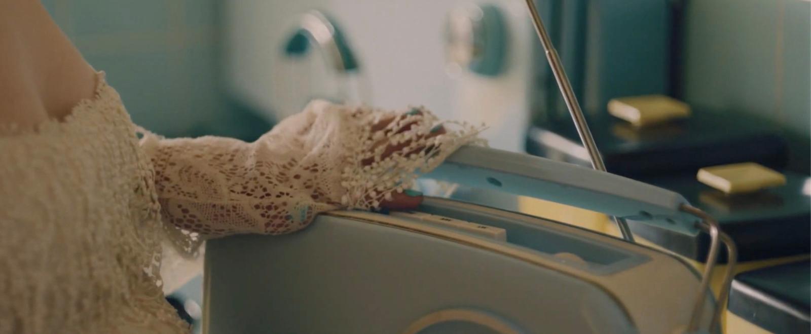 a woman is holding a piece of luggage