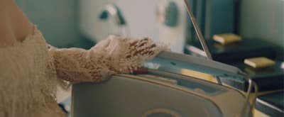 a woman is holding a piece of luggage