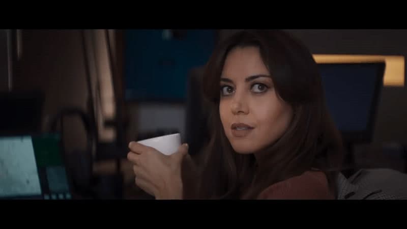 a close up of a person holding a cup