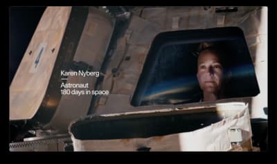 a woman looking out the window of a space shuttle