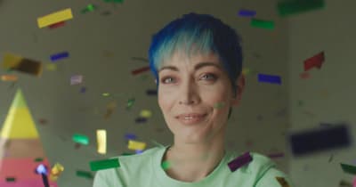 a woman with blue hair is surrounded by confetti