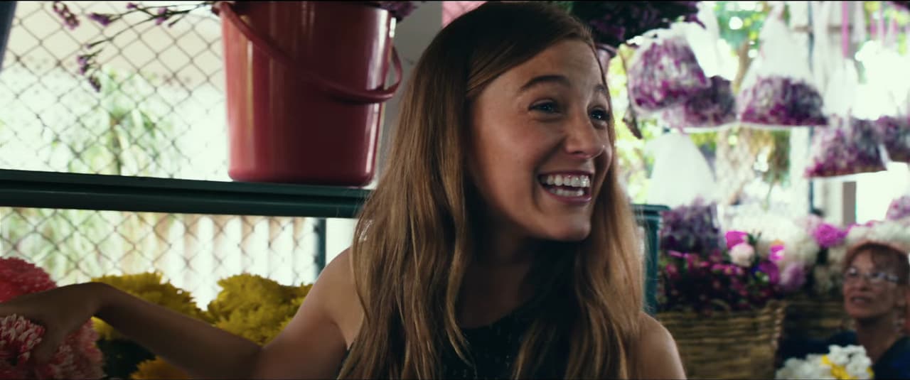 a woman is smiling in a flower shop
