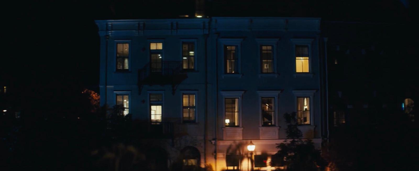 a large white building with windows lit up at night