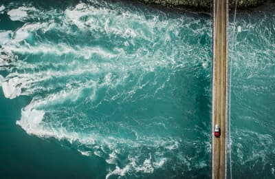 an aerial view of the ocean with a boat in the water