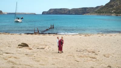 a woman standing on top of a sandy beach