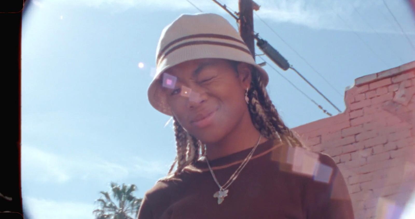 a person with a hat and a cell phone