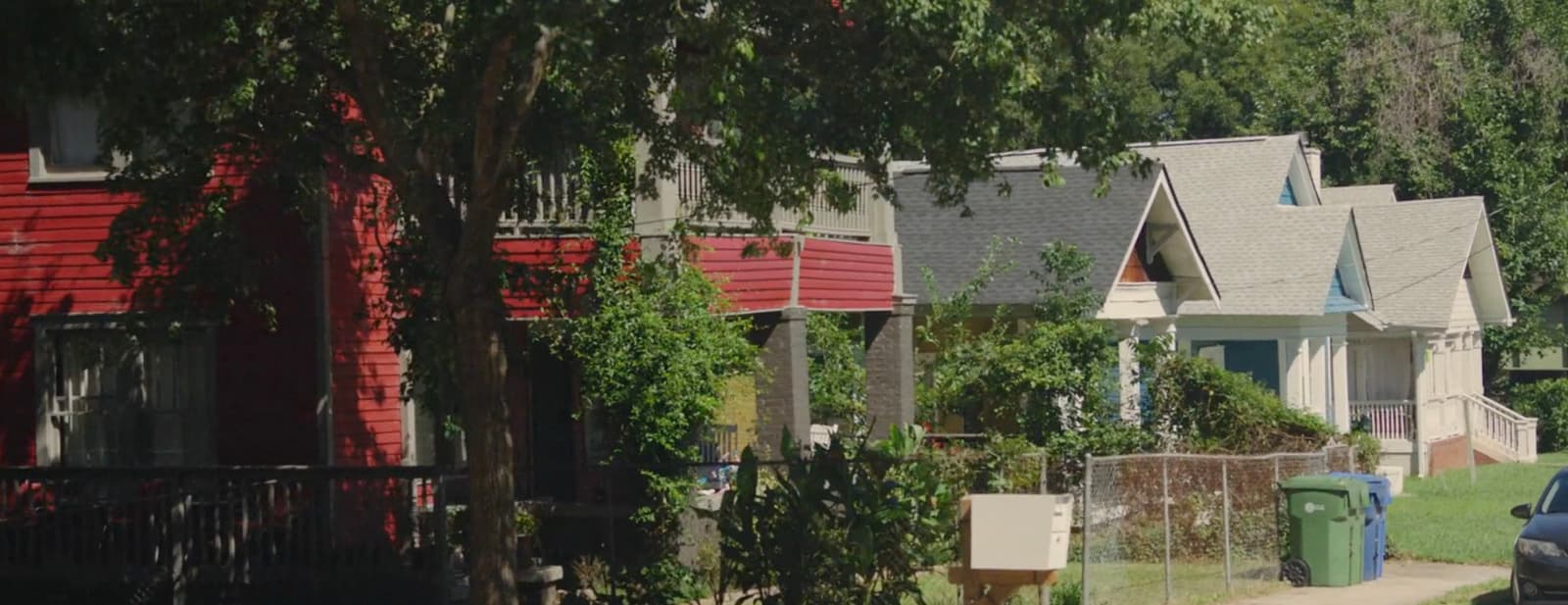 a row of houses with a car parked in front of them
