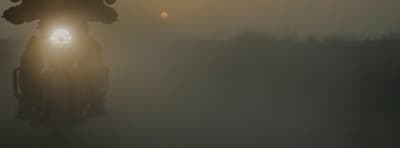 a person is riding a bike in the fog