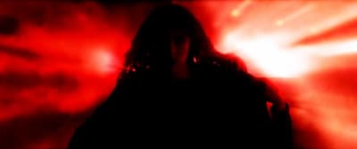 a person standing in front of a red light
