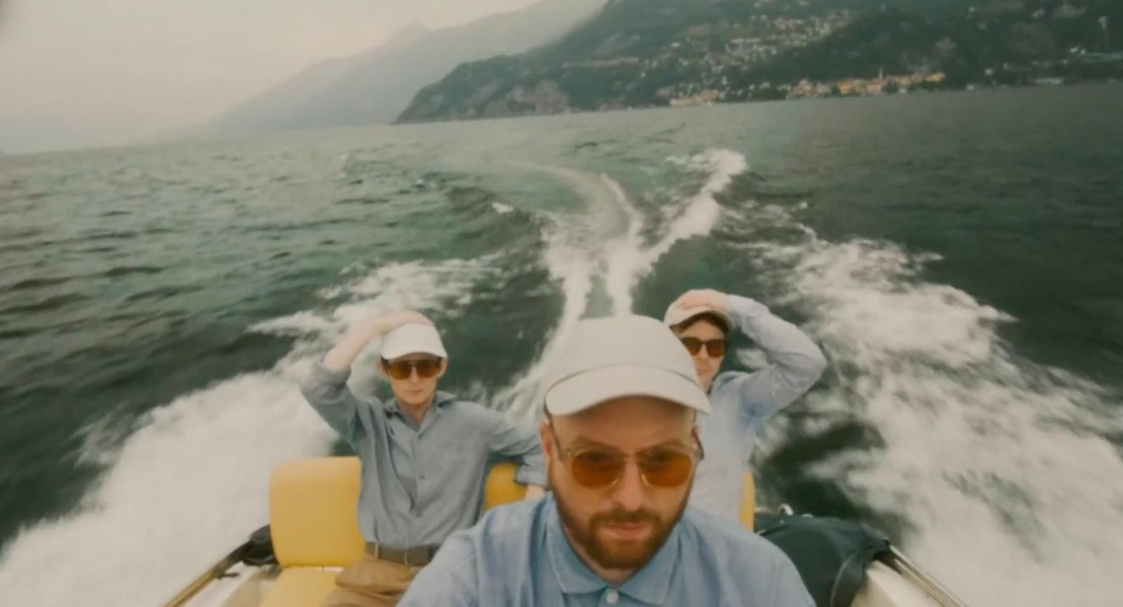 two men riding in a boat on a lake