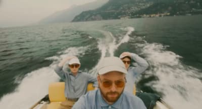 two men riding in a boat on a lake