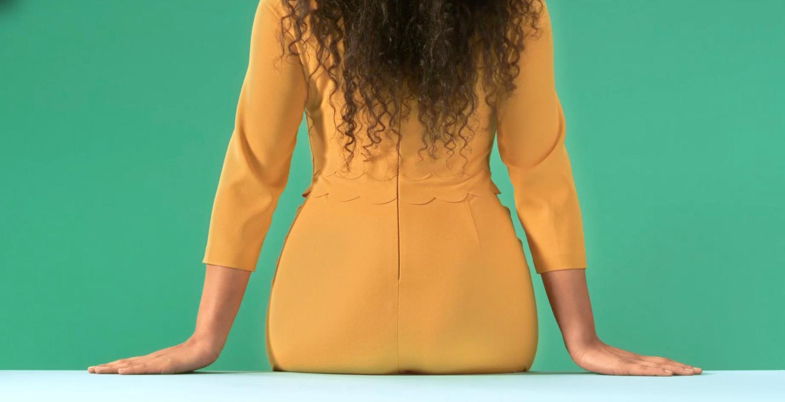 a woman with long hair sitting on a table