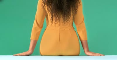 a woman with long hair sitting on a table