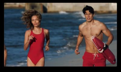 a man and a woman running on the beach