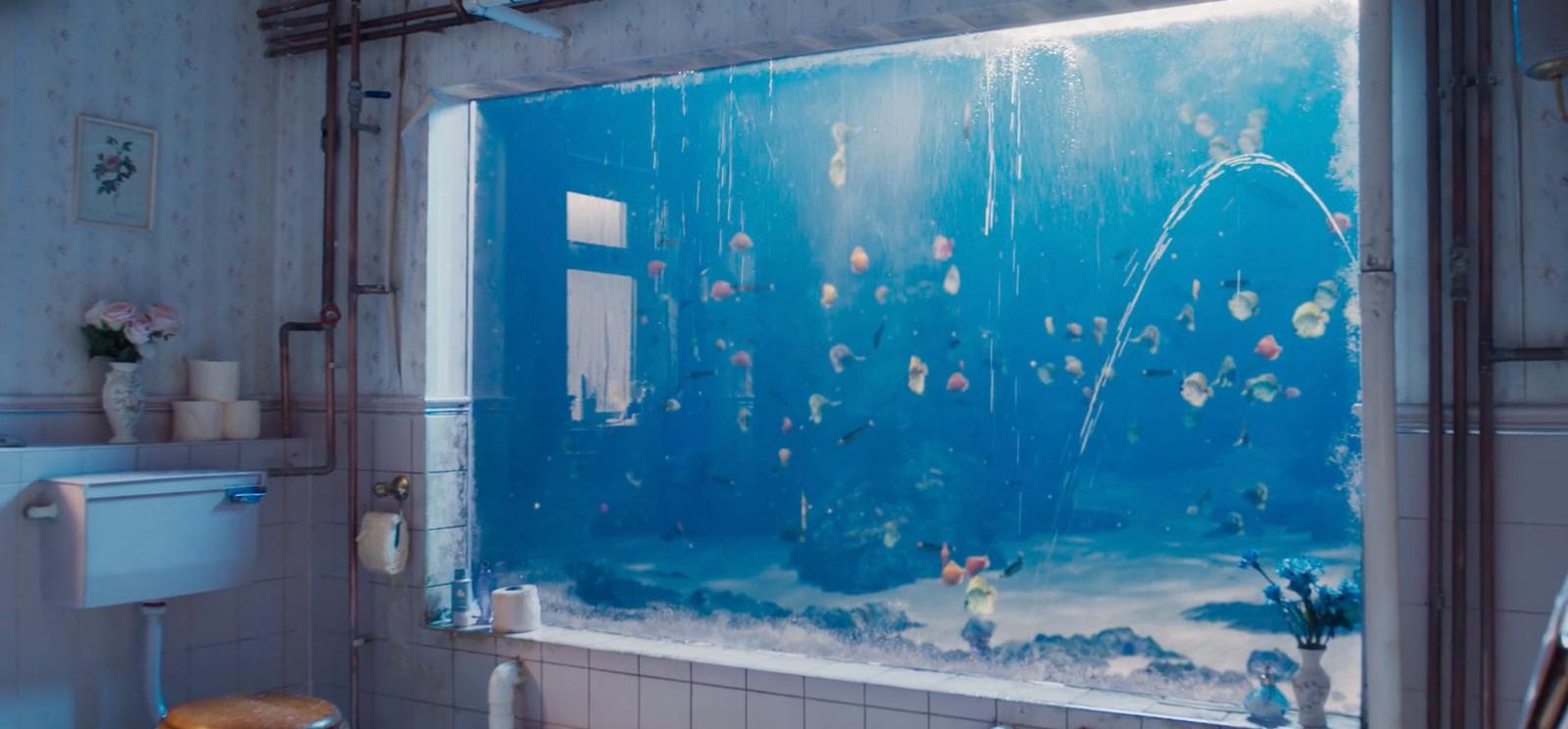 a bathroom with a fish tank and a toilet