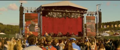 a crowd of people standing around a stage