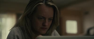a woman looking at a tablet computer screen