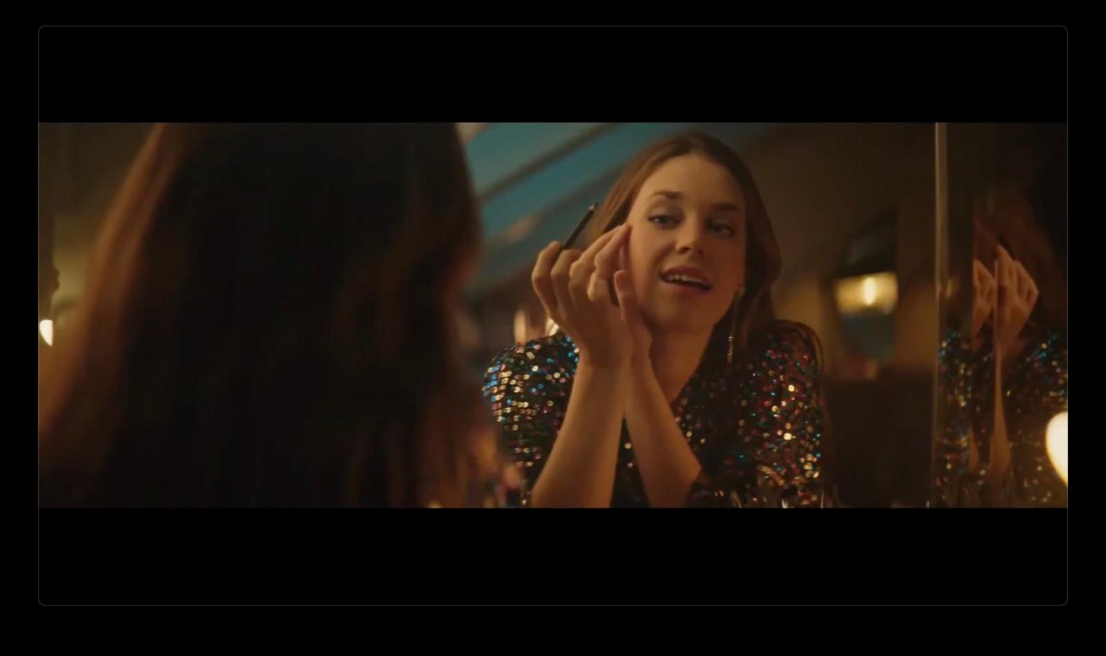 a woman looking at herself in a mirror