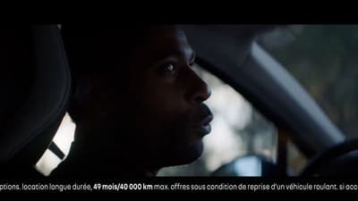 a man driving a car in the dark