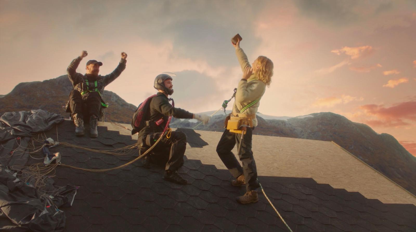 a group of people standing on top of a roof