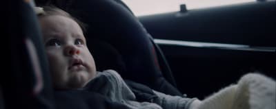 a small child sitting in a car seat