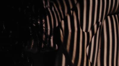 a close up of a person's stripped shirt and tie